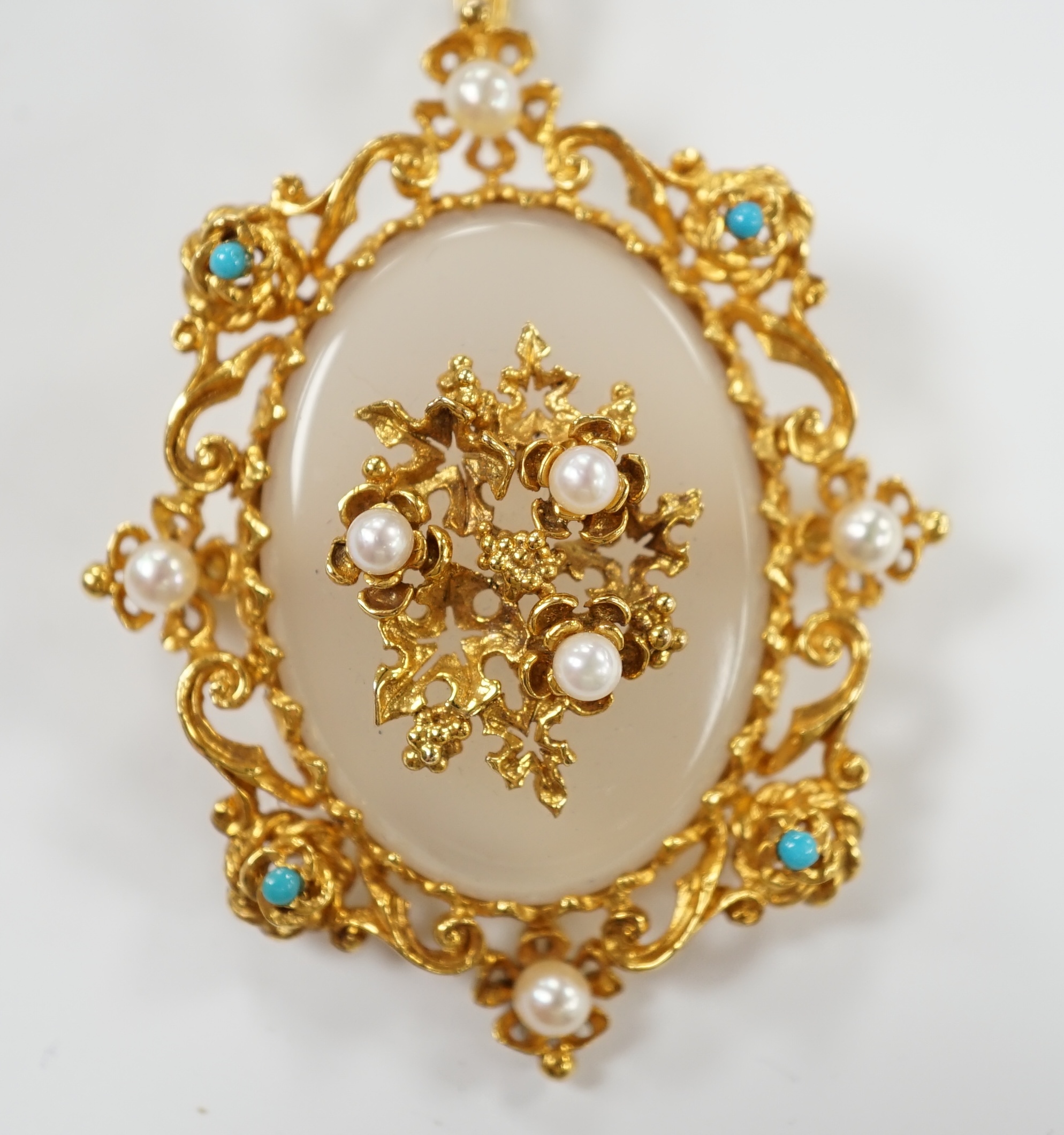 A 1970's Victorian style 9ct gold, white chalcedony, turquoise and seed pearl set pendant brooch, overall 59mm, gross weight 16.8 grams.